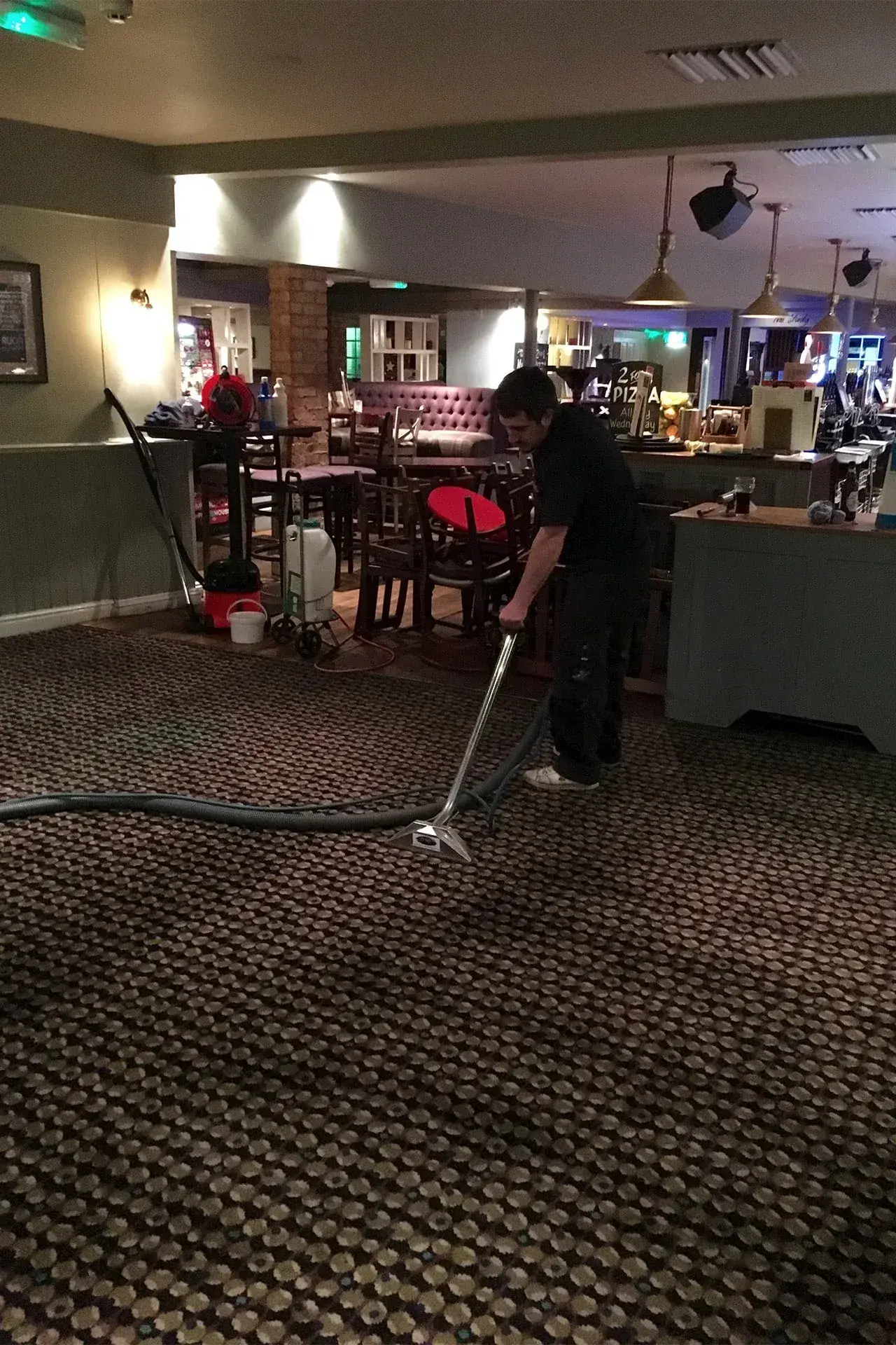 Professional commercial carpet cleaning technician at work