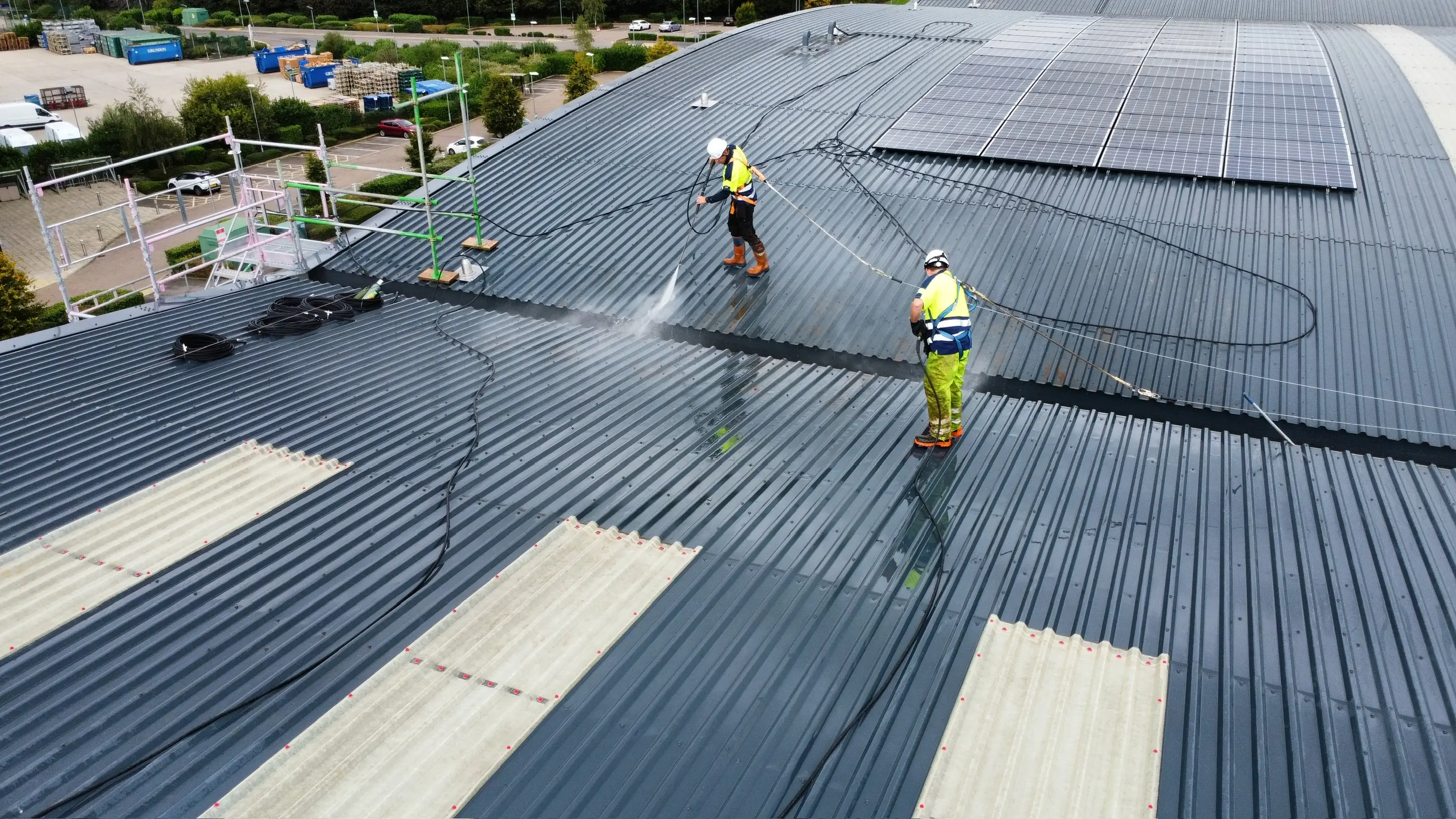 Before and after commercial roof cleaning showing moss removal