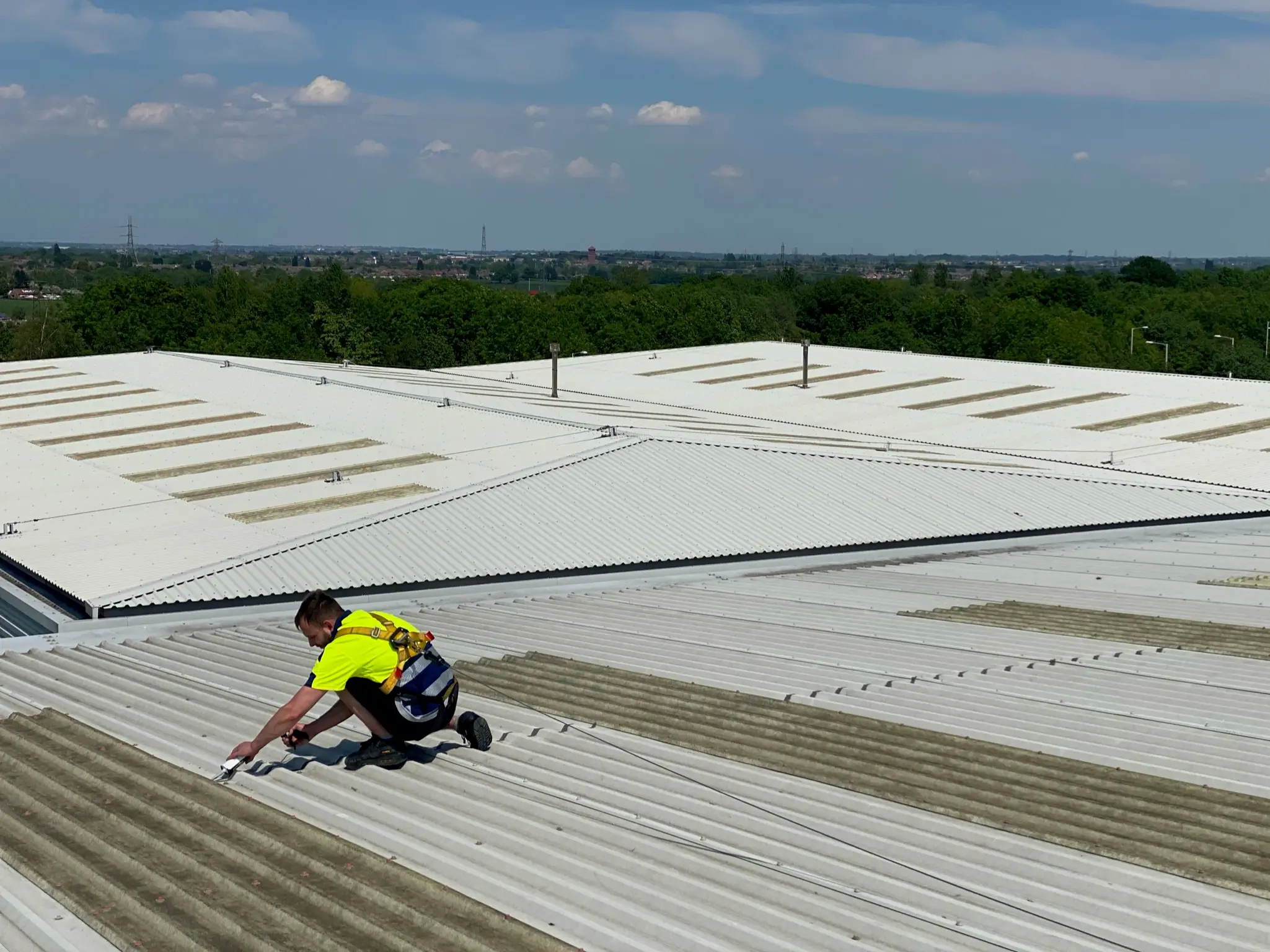 Close-up of deteriorating cut edges on a commercial roof requiring restoration