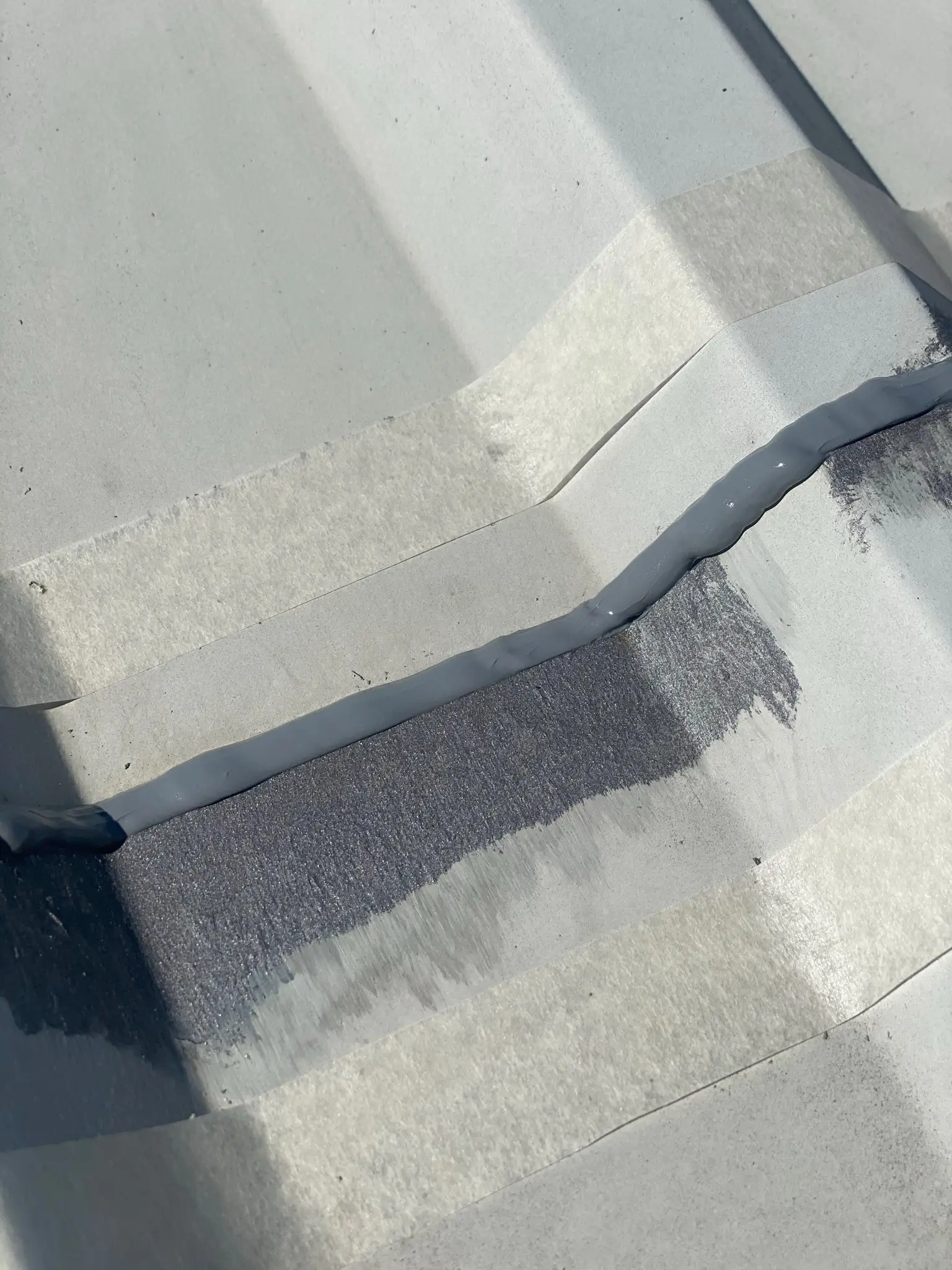 Professional roof coating application on a commercial building