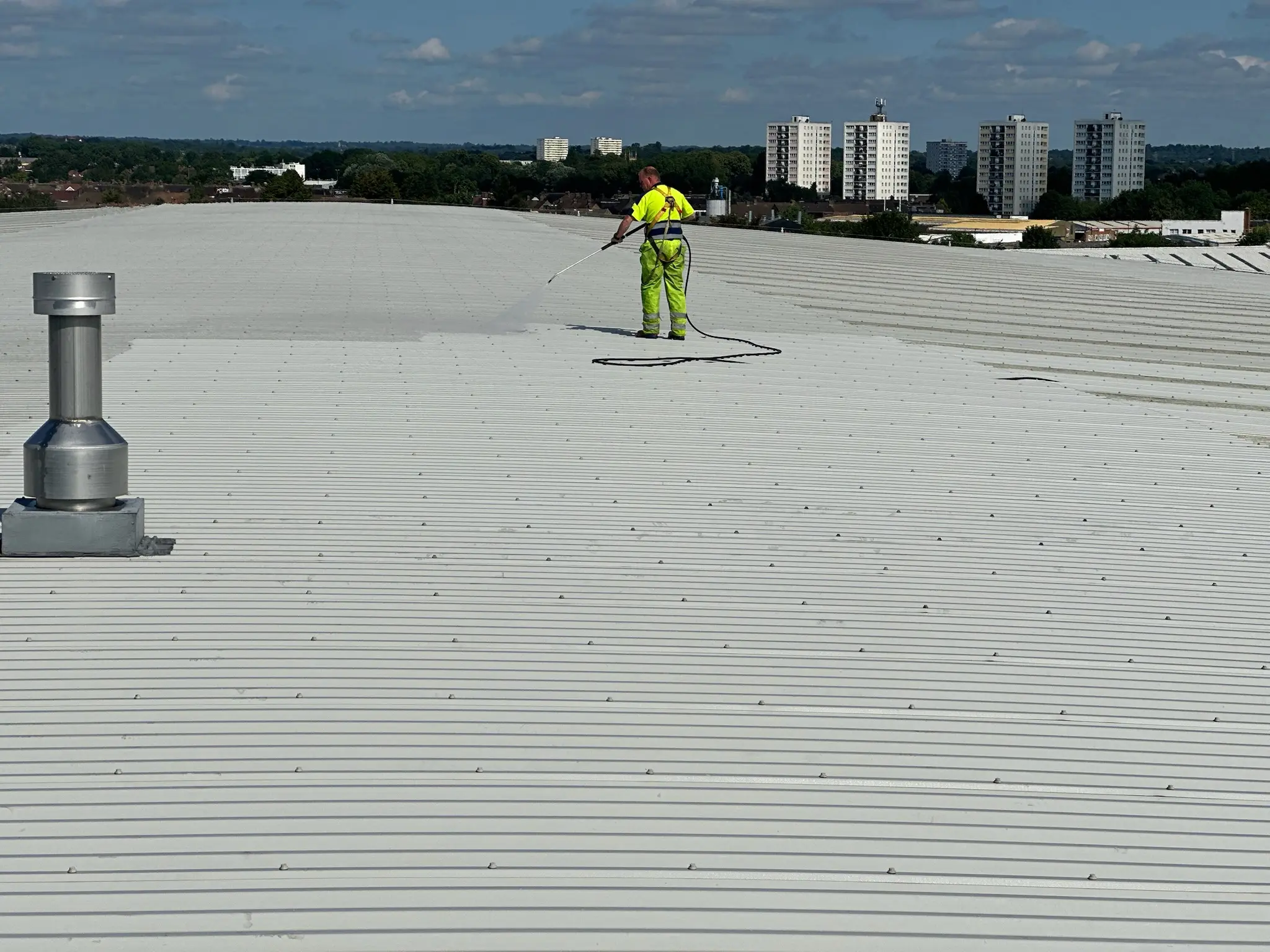 Commercial roof cleaning by DMC Facilities Management — removing moss and algae from a commercial property