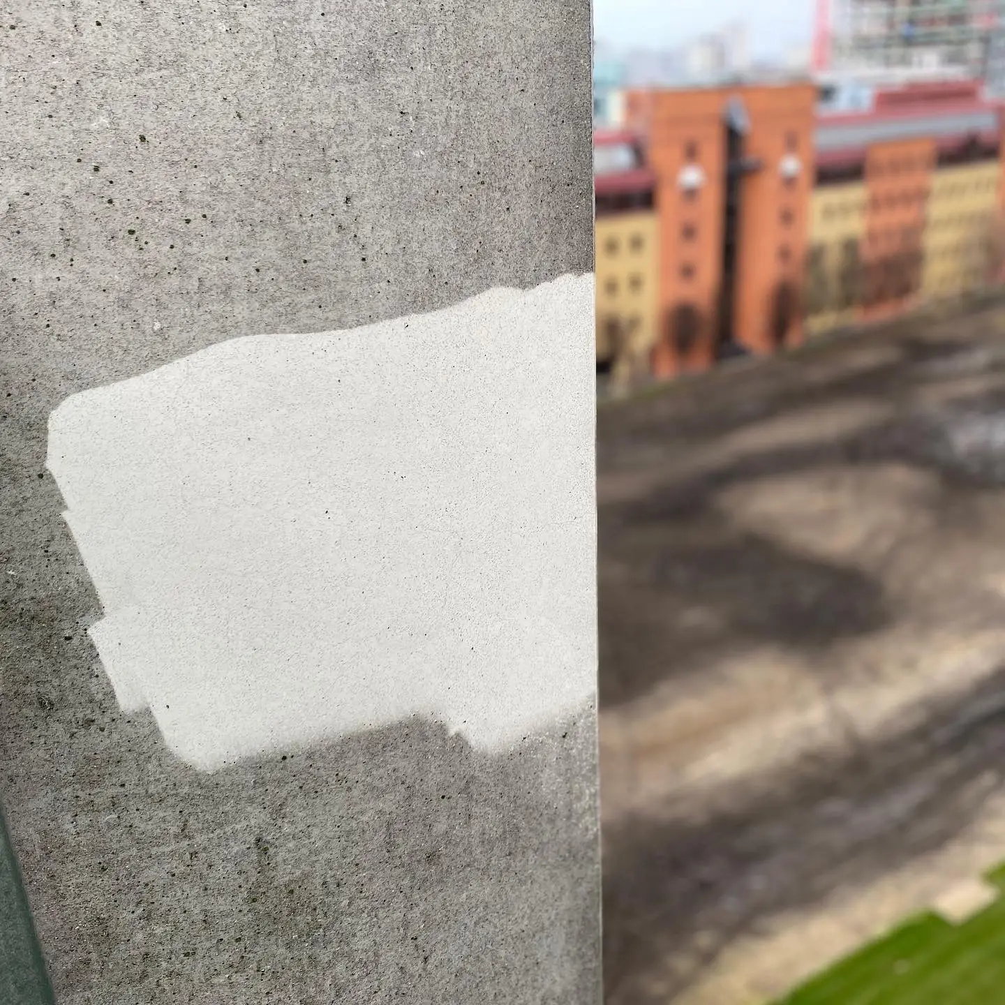 Soft washing a rendered commercial building exterior